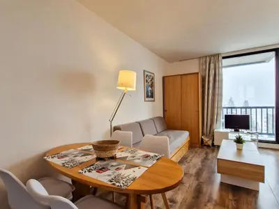 a living room with a table and a couch at Studio lumineux proche des pistes avec balcon - FR-1-425-169 in Arâches-la-Frasse