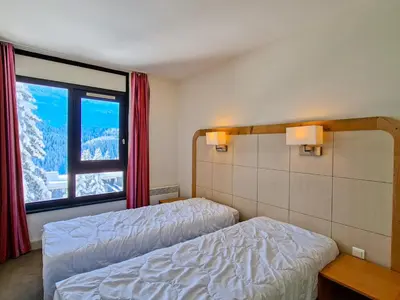 a bedroom with two beds and a large window at Appartement lumineux 2 pièces, proche des pistes avec balcon - FR-1-425-175 in Arâches-la-Frasse