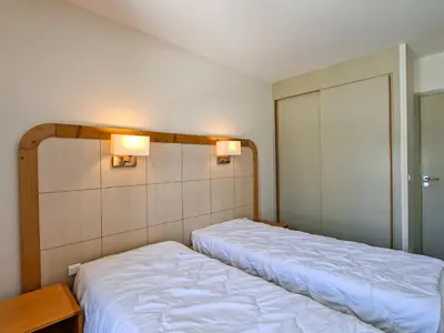 a bedroom with two beds and two lights on the wall at Appartement lumineux 2 pièces, proche des pistes avec balcon - FR-1-425-175 in Arâches-la-Frasse