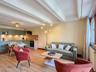 a living room with a couch and a table at Appartement rénové 2 pièces pour 6, balcon proche pistes et commerces - FR-1-425-158 in Arâches-la-Frasse