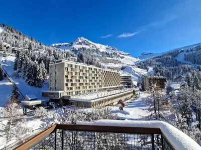 a hotel in the snow with a mountain at Appartement rénové 2 pièces pour 6, balcon proche pistes et commerces - FR-1-425-158 in Arâches-la-Frasse
