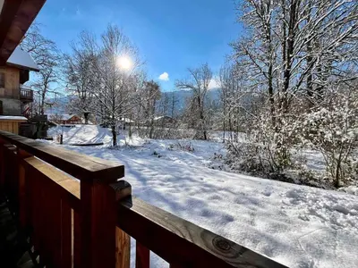 a kitchen with wooden cabinets and a sink and a counter at Appartement T3 cosy près du centre avec terrasse et parking - FR-1-624-114 in Samoëns