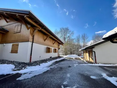 a kitchen with wooden cabinets and a sink at Appartement T3 cosy près du centre avec terrasse et parking - FR-1-624-114 in Samoëns