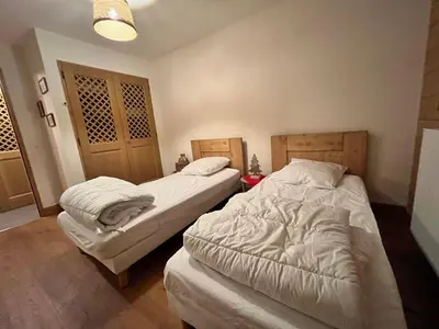 a bedroom with two beds in a room at Appartement T3 cosy près du centre avec terrasse et parking - FR-1-624-114 in Samoëns