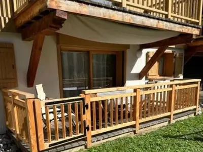 a mattress sitting on a porch with a table at Appartement T3 cosy près du centre avec terrasse et parking - FR-1-624-114 in Samoëns