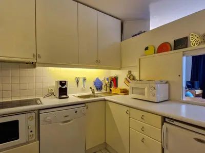a kitchen with white cabinets and a sink and a microwave at Appartement confortable au pied des pistes avec Wifi gratuit - FR-1-425-137 in Arâches-la-Frasse