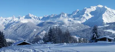 a snowy mountain range with snow covered mountains at L'Eterlou 74 in Sallanches