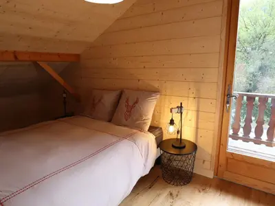 a bedroom with a bed in a log cabin at Chalet spacieux, proche des commerces, animaux admis ! - FR-1-624-118 in Samoëns