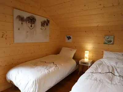 a bedroom with two beds in a log cabin at Chalet spacieux, proche des commerces, animaux admis ! - FR-1-624-118 in Samoëns