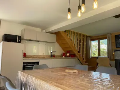 a kitchen with a table and chairs in a room at Chalet spacieux, proche des commerces, animaux admis ! - FR-1-624-118 in Samoëns