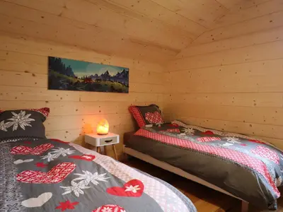a bedroom with two beds in a log cabin at Chalet spacieux, proche des commerces, animaux admis ! - FR-1-624-118 in Samoëns