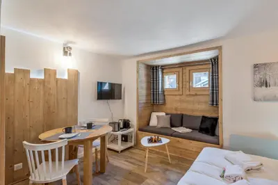 a living room with a table and a couch at Studio Loup - L'Igloo - Welkeys in Combloux
