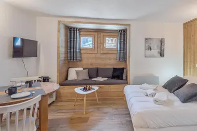 a living room with a couch and a table at Studio Loup - L'Igloo - Welkeys in Combloux