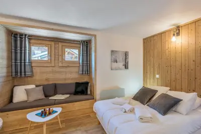 a living room with a large white couch and a table at Studio Loup - L'Igloo - Welkeys in Combloux