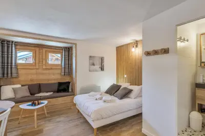 a living room with a couch and a table at Studio Loup - L'Igloo - Welkeys in Combloux