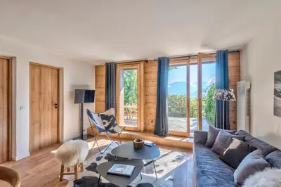a living room with a couch and a table at Appartement Vue Montagnarde - Welkeys in Combloux