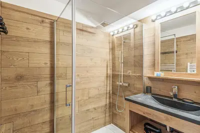 a bathroom with a sink and a shower at Appartement Vue Montagnarde - Welkeys in Combloux