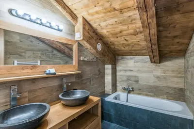 a bathroom with a sink and a bath tub at Appartement Alpage - Welkeys in Combloux