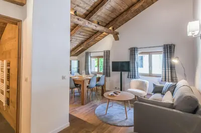 a living room with a couch and a table at Appartement La Combe aux Loups - Welkeys in Combloux