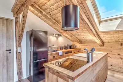a kitchen with a sink and a stove at Appartement La Pause de l'Ours - Welkeys in Combloux