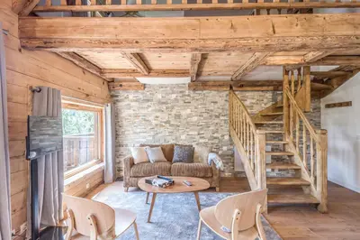 a living room with a couch and a table at Appartement La Pause de l'Ours - Welkeys in Combloux