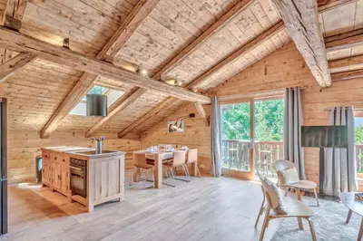 a kitchen and dining room with a table and chairs at Appartement La Pause de l'Ours - Welkeys in Combloux
