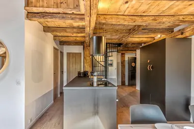 a kitchen with wooden ceilings and a counter top at Appartement Le Mont-Blanc - Welkeys in Combloux