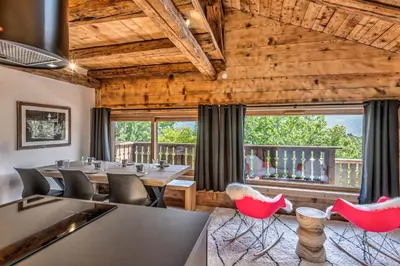 a dining room with tables and red chairs at Appartement Le Mont-Blanc - Welkeys in Combloux