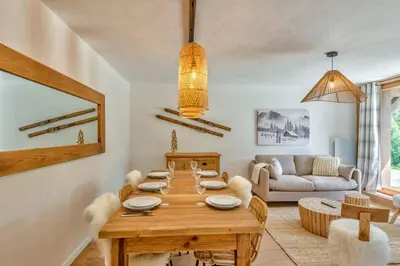 a living room with a wooden table and a couch at Appartement Snow - Welkeys in Combloux