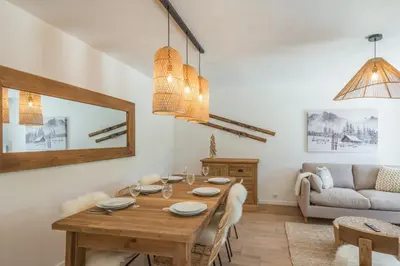 a living room with a wooden table and a couch at Appartement Snow - Welkeys in Combloux