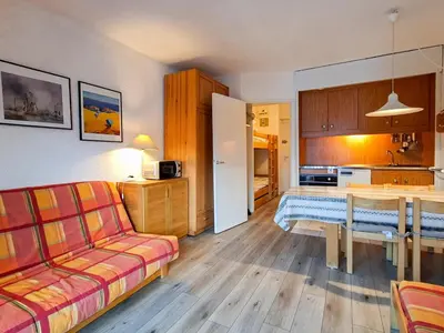 a living room with a couch and a table at Studio lumineux avec balcon et casier à ski proche des pistes - FR-1-425-185 in Arâches-la-Frasse