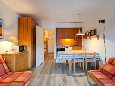 a living room with a table and a kitchen at Studio lumineux avec balcon et casier à ski proche des pistes - FR-1-425-185 in Arâches-la-Frasse