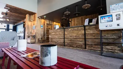 a restaurant with wooden walls and a wooden table at Les Roches du Mont Blanc - Résidence & Spa in Combloux