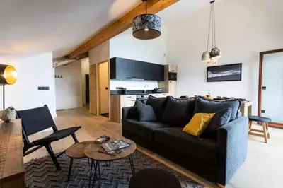 a living room with a couch and a table at Les Roches du Mont Blanc - Résidence & Spa in Combloux