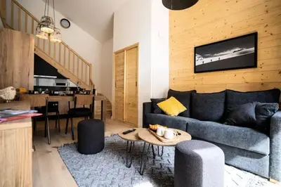 a living room with a couch and a table at Les Roches du Mont Blanc - Résidence & Spa in Combloux