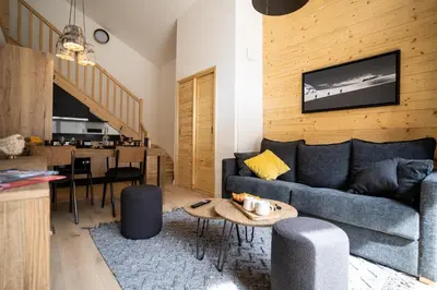 a living room with a couch and a table at Les Roches du Mont Blanc - Résidence & Spa in Combloux
