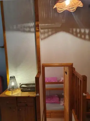 a bedroom with a bunk bed and a mirror at Les Pierres Blanches 2 pieces cosy et fonctionnel in Les Contamines-Montjoie