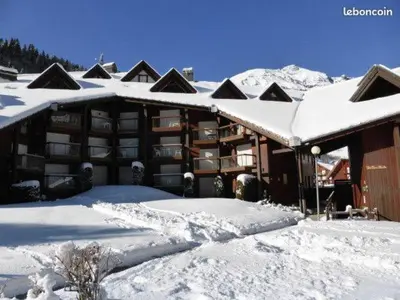 a building covered in snow with snow covered roofs at Les Pierres Blanches 2 pieces cosy et fonctionnel in Les Contamines-Montjoie