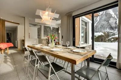 a dining room with a table and some chairs at Chalet Safari. Face au Mont-Blanc. in Chamonix-Mont-Blanc