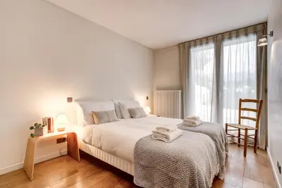 a bedroom with a large bed with two towels on it at Chalet Safari. Face au Mont-Blanc. in Chamonix-Mont-Blanc