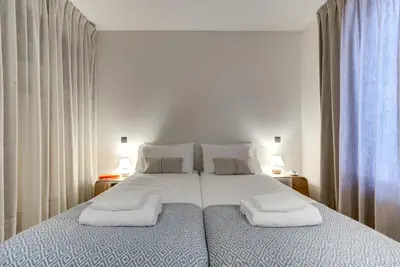 a bedroom with a large bed with two towels on it at Chalet Safari. Face au Mont-Blanc. in Chamonix-Mont-Blanc