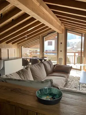 a living room with a couch and a large window at LE 1307 in Megève
