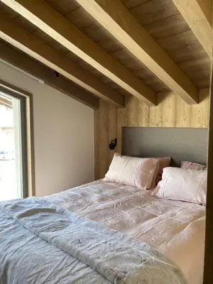a bedroom with a large bed with pillows on it at LE 1307 in Megève