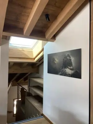 a hallway with a picture on the wall and stairs at LE 1307 in Megève