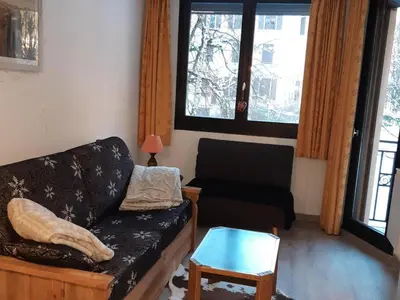 a living room with a couch and a table at Appartement Chamonix - 2 Pièces, Casier à ski, Près des bus - FR-1-517-62 in Chamonix-Mont-Blanc