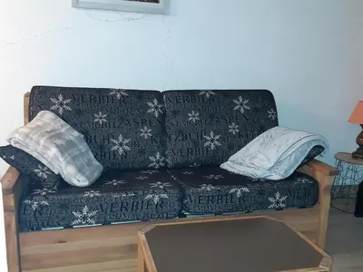 a couch with two pillows on top of it at Appartement Chamonix - 2 Pièces, Casier à ski, Près des bus - FR-1-517-62 in Chamonix-Mont-Blanc