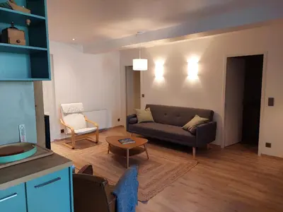 a living room with a couch and a table at Appartement rénové avec jardin, proche activités et centre, piscine et randonnées à 5mn - FR-1-517-60 in Chamonix-Mont-Blanc