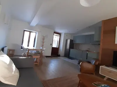 a living room with a couch and a table in it at Appartement rénové avec jardin, proche activités et centre, piscine et randonnées à 5mn - FR-1-517-60 in Chamonix-Mont-Blanc