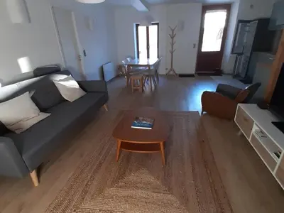 a living room with a couch and a table at Appartement rénové avec jardin, proche activités et centre, piscine et randonnées à 5mn - FR-1-517-60 in Chamonix-Mont-Blanc