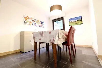 a dining room with a table and chairs at Cozy Alpine Stay Séjour cosy au centre in Chamonix-Mont-Blanc